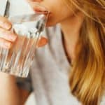 woman drinks glass of water