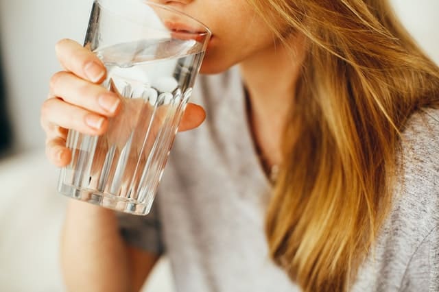 woman drinks glass of water