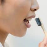 woman about to brush teeth