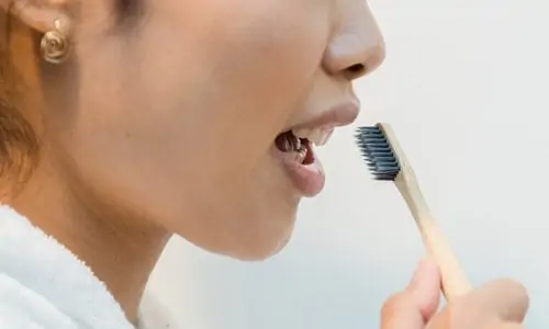 woman about to brush teeth