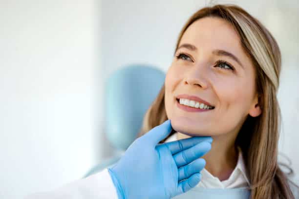Satisfied young woman came to see the dentist.
