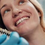 Veneer, smile and consulting with woman at dentist