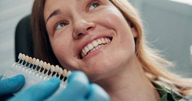 Veneer, smile and consulting with woman at dentist